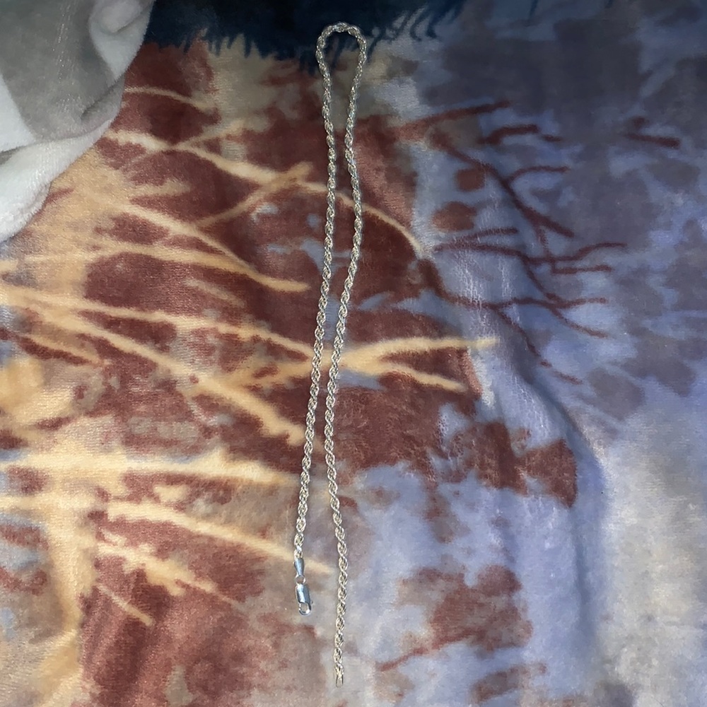 Three rope chains one is gold and two silver real